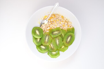 a plate of delicious oatmeal with green kiwi in the morning