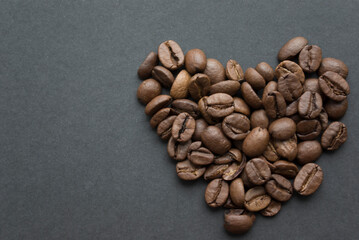 Heart-shaped coffee beans on a black background top view