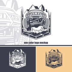 Logo of front view off-road car against a background of mountains in a shield. Monochrome layout. © slava