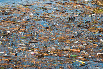 close-up of miscellaneous garbage in the sea water near the shore