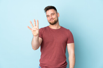 Fototapeta premium Russian handsome man over isolated background happy and counting four with fingers