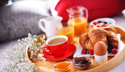 A tray with breakfast on a bed in a hotel room