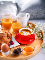 A tray with breakfast on a bed in a hotel room