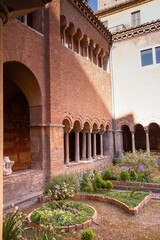 Fototapeta na wymiar The Cloister of The Basilica of San Lorenzo fuori le Mura built in the 12th century, has three and four light windows, that can be seen on the upper floor overlook the garden
