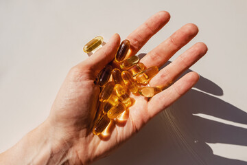 Woman's hand close-up holding a lot of gel pills