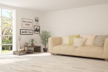 Fototapeta premium White living room with sofa and summer landscape in window. Scandinavian interior design. 3D illustration