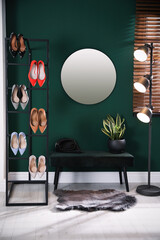 Hallway interior with storage rack, stylish women's shoes and bench