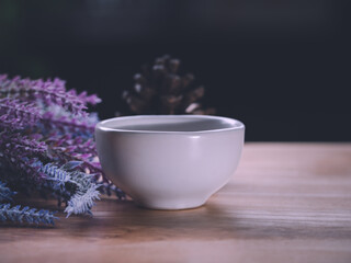The essential oil or aromatherapy falling from glass dropper into ceramic bowl organic bio alternative medicine, brown bottle.