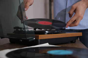 Man using turntable at home, closeup view