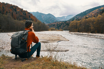 Fototapeta premium traveler in the autumn in the mountains in nature on the banks of the river