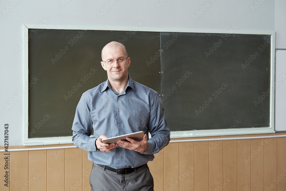 Poster contemporary professor of university in smart casualwear holding digital tablet while preparing for 