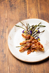 Wild Asparagus baked with bacon and spices. Healthy food.