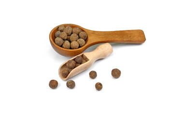 Allspice, pimento spice, Jamaican pepper pile in a wooden spoon isolated on white background