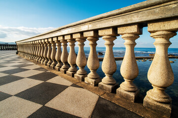 Fototapeta na wymiar The columns of the balustrade overlooking the sea of ​​the Terrazza Mascagni Livorno