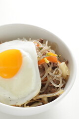 sunny side up fried egg on Korean Japchea green noodles stir fried