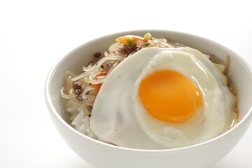 sunny side up fried egg on Korean Japchea green noodles stir fried