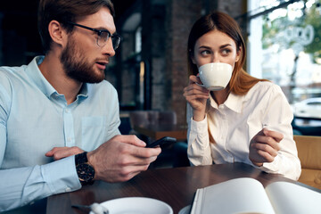 young couple in cafe work colleagues breakfast lifestyle