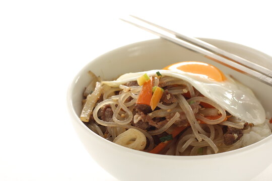 sunny side up fried egg on Korean Japchea green noodles stir fried