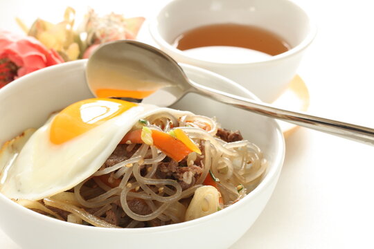 sunny side up fried egg on Korean Japchea green noodles stir fried