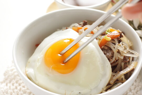 sunny side up fried egg on Korean Japchea green noodles stir fried
