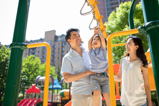 Happy young family playing in amusement park