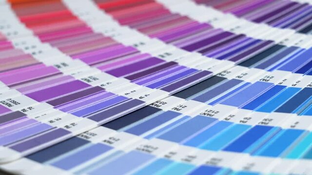 Close-up on color palette guide for printing and painting. Horizontal video of the catalog of color samples to be chosen for graphic, painting, printing a new creative business work. 