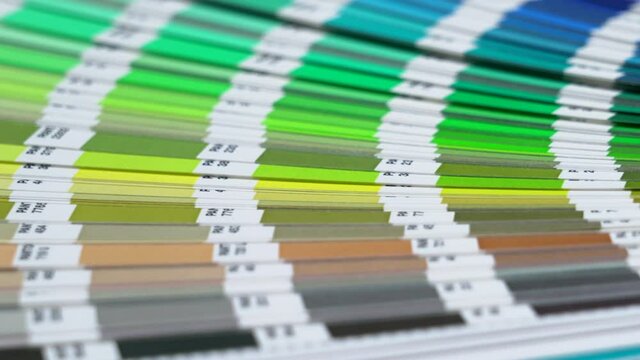 Close-up on color palette guide for printing and painting. Horizontal video of the catalog of color samples to be chosen for graphic, painting, printing a new creative business work. 