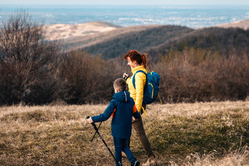 Mother and son hiking together in the mountains.	