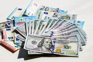 Money. Dollars, euros. Dollars are fanned out. Money on the table. Bribe. cash, currency, dollar, business, finance, usa, 100, bills. Cents and Euros scattered