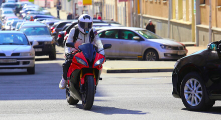 city traffic with a motorbike and cars