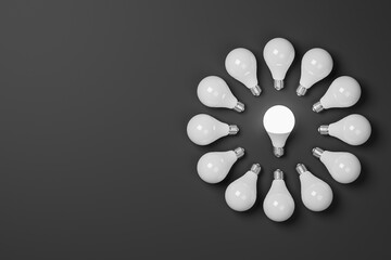 Circle composed of lighted bulbs on a dark background. Lighting and energy saving concept. 3d render. - 427196269