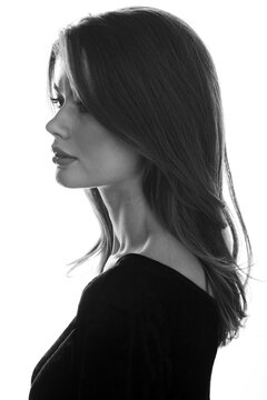 Black and white photo of beautiful profile portrait of a young woman with hairstyle.