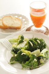boiled broccoli and mayonnaise salad with carrot juice and bread