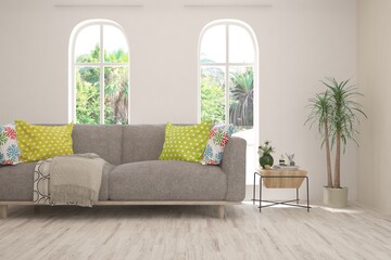 White living room with sofa and summer landscape in window. Scandinavian interior design. 3D illustration