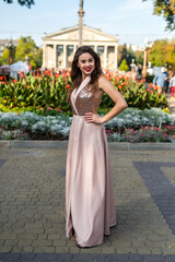 Fashion full-length portrait pretty lady in attractive ball gown dress at city street