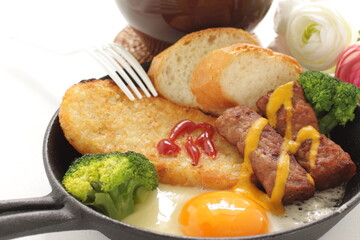 hashed brown and sausage with sunny side up fried egg for gourmet breakfast
