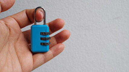 Padlock luggage lock code in hand on white background.