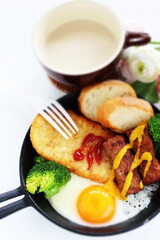 hashed brown and sausage with sunny side up fried egg for gourmet breakfast