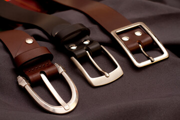 Men's belts leather background. Handmade leather goods. Leather sewing workshop.