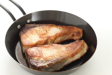 Chinese food, pan fried yellow tail fish fillet on pan