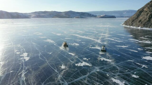 A hovercraft walks on the ice of Lake Baikal on a sunny day
