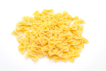 Dry uncooked farfalle pasta on white background