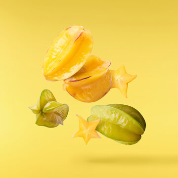 Creative image with fresh yellow carambola falling in the air