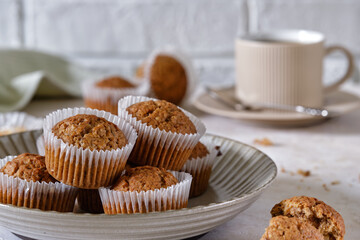 Carrot cupcakes in a round plate with a fragrant coffee on a white wall