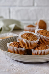 Carrot cupcakes in a round plate with a fragrant coffee on a white wall