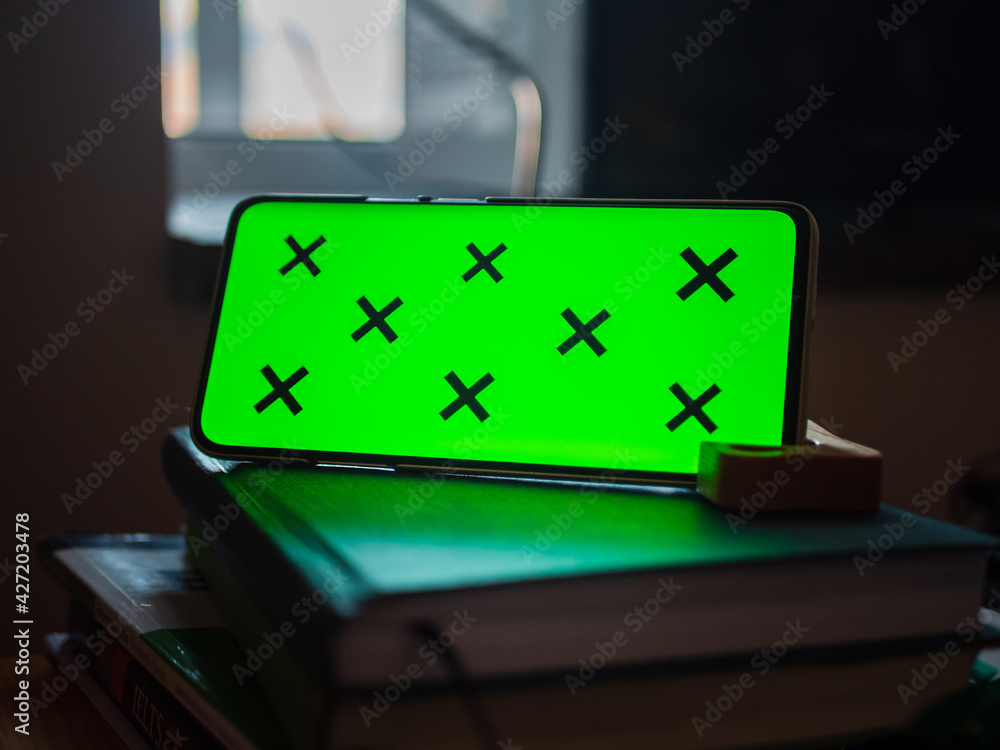 Poster smartphone with a green screen put horizontally on notebooks, free space for editing and text