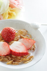 freshness sliced strawberries and corn flakes