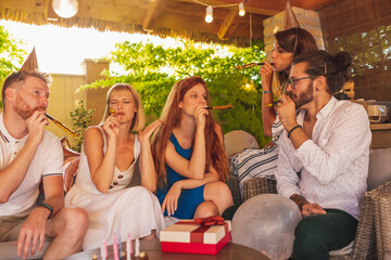 People singing birthday song to a friend