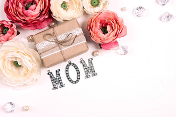 Festive white background with peony flowers, gift and jewelry word mom.