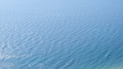 Ripples on the surface of blue sea water.